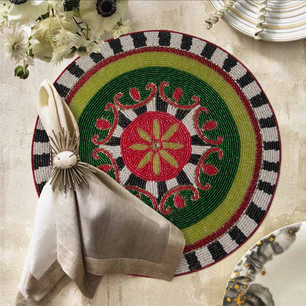 Set of 2 embroidered beaded placemats with festive poinsettia design, perfect for holiday table decor.
