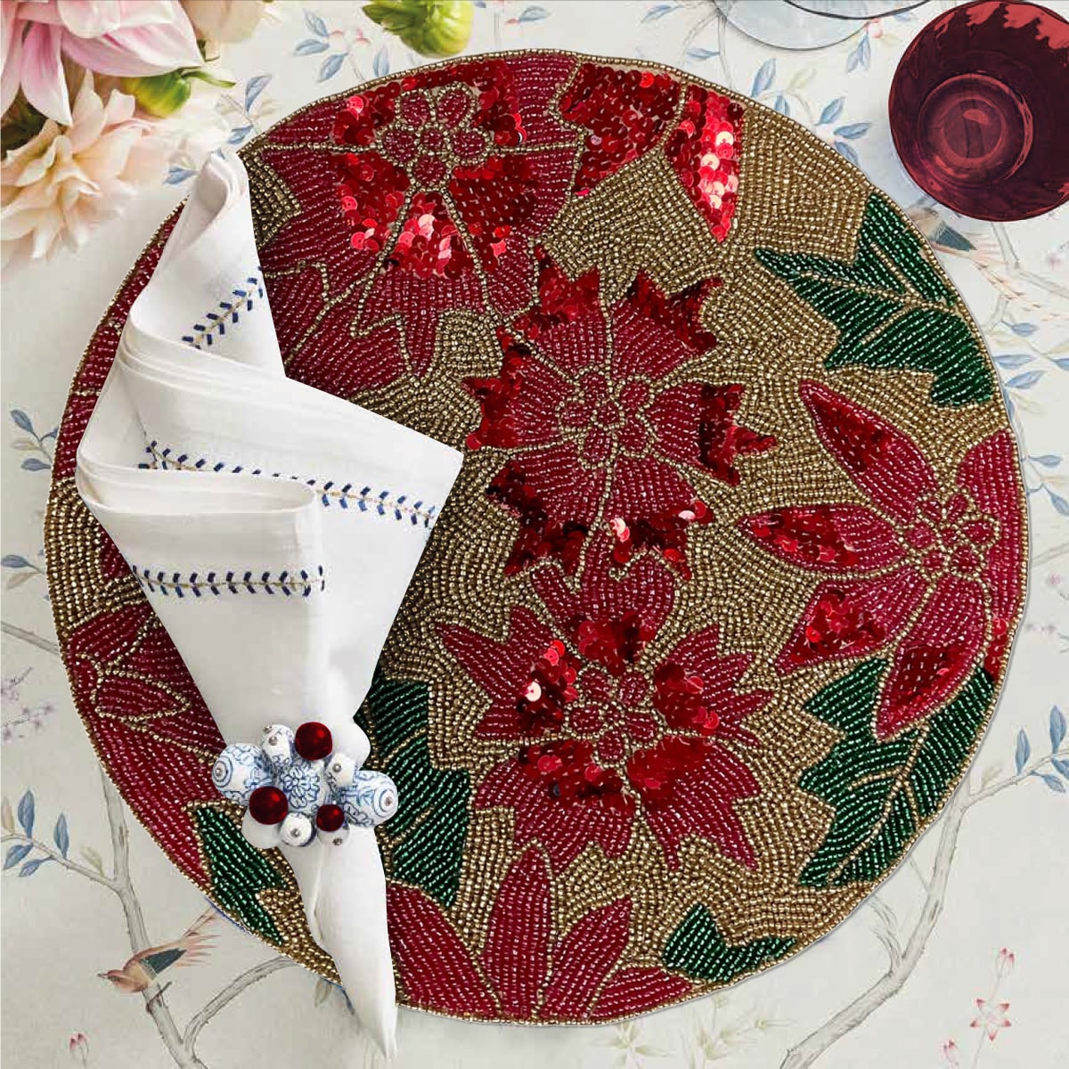Set of 2 embroidered beaded placemats with festive poinsettia design, ideal for holiday table decor.